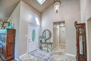 Tiled foyer entrance featuring lofted ceiling with