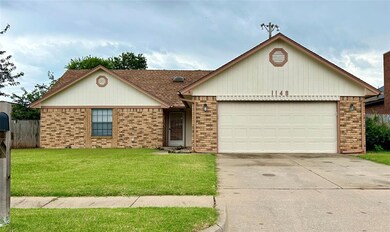 Ranch-style house with a garage and a front yard