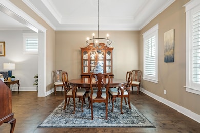 Dining room with dark hardwood / wood-style floors