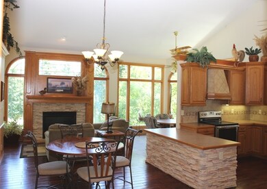 Hearth room with gas insert stone fireplace with b
