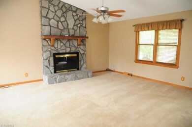 Large living room with view of fireplace.
