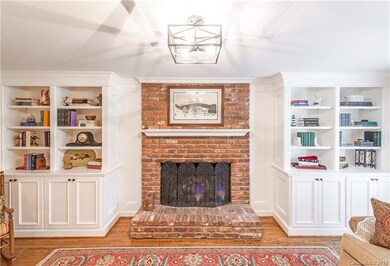 Built-ins surround a rustic brick hearth for a war