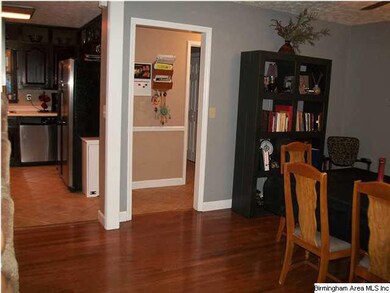 Looking from formal dining into the kitchen.  The guest half bath is on the right down the short hall.