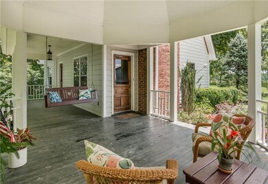 The porch leads into the front door with entry foyer and staircase, and also leads directly into the living room. The doors are matching Victorian doors circa the 1890's.