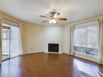 Unfurnished living room with baseboards, wood fin