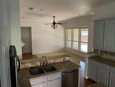 Kitchen featuring dark wood-type flooring, sink, s