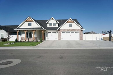 View of front of home featuring a porch, brick siding, a garage, and concrete driveway