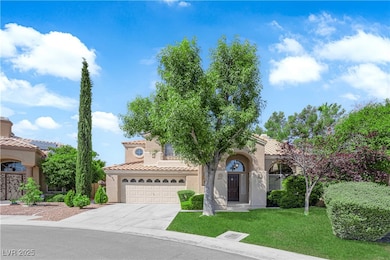 Mediterranean / spanish house with stucco siding, concrete driveway, and a front yard