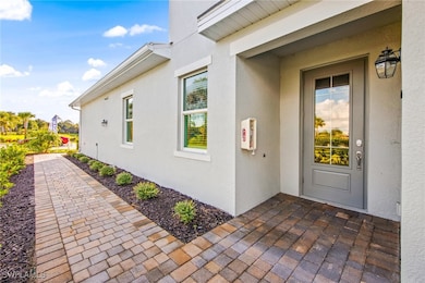View of exterior entry featuring a patio area and