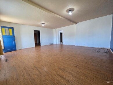 Empty room with wood finished floors and baseboards