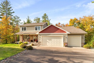 View of front of property with a garage, a porch, 