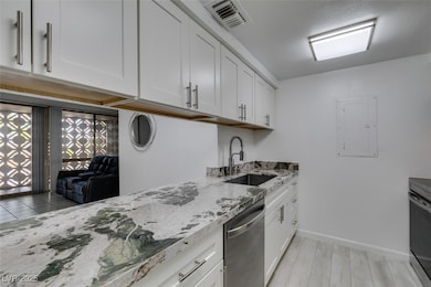 Kitchen with dishwasher, a sink, electric panel, w