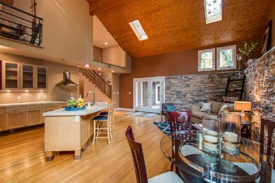 Spacious open kitchen with dining area opens to lovely patio