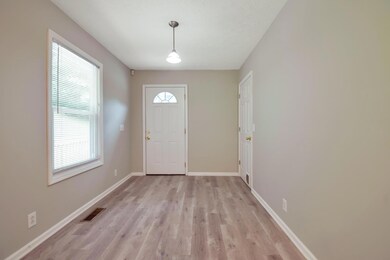 Eat-in area of kitchen with a view of backyard.