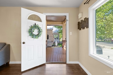 Entrance foyer featuring dark wood-type flooring and baseboards