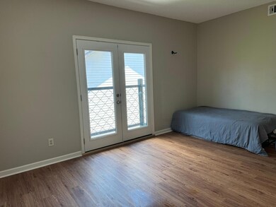 Unfurnished bedroom with french doors, wood finis