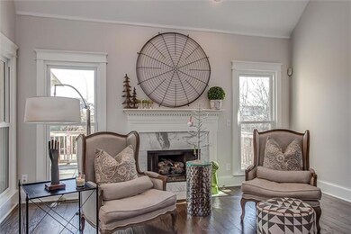 White Carrera marble forms the surround & frames the fireplace w/gas log insert. Overlooking an expanded rear deck, the room is graciously illuminated w/natural light by 2 windows that flank the fireplace, plus one, to enjoy the outside inside!