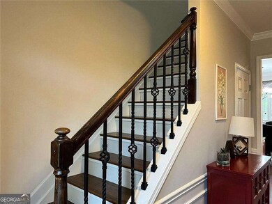 Stairway with ornamental molding and baseboards