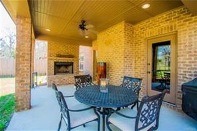 Check out the covered rear patio with fiureplace.