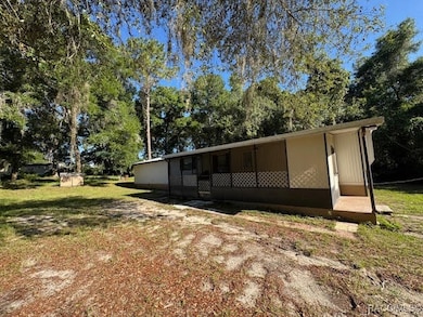 Side of mobile featuring screened in porch.