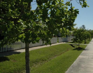 Photo. White picket fences and sidewalks are hallm