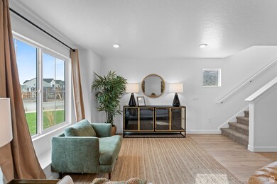 Living area with light wood-style floors, stairs, and recessed lighting