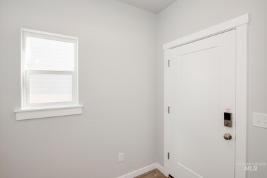 Doorway to outside featuring wood finished floors and baseboards