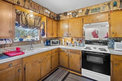 Kitchen with under cabinet range hood, white appl