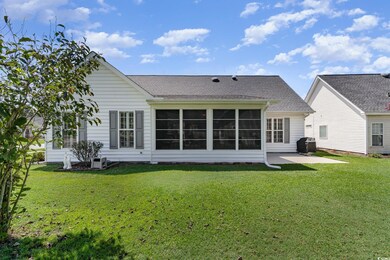 Back of property with central AC and a yard