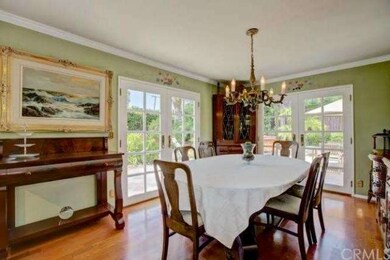 Formal dining room with french doors leading to ou