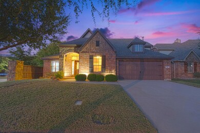 View of front of house featuring a yard and a gara