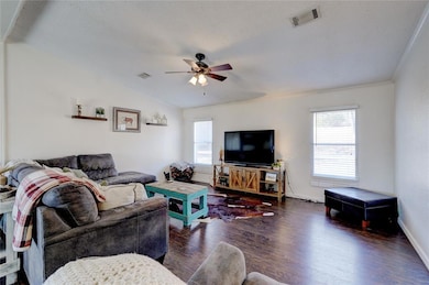 Living room featuring ceiling fan, lofted ceiling,