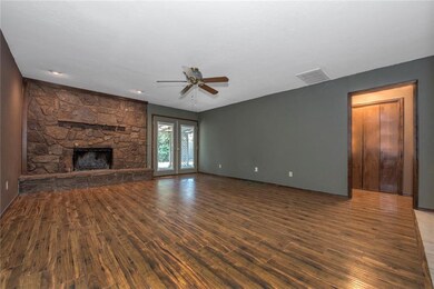 Pergo flooring, stone fireplace enhance the large 