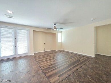 Empty room featuring ceiling fan and baseboards