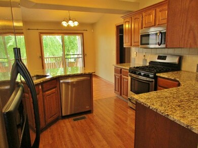 The kitchen opens to an informal dining area which
