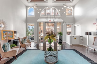 Sitting room with a high ceiling, tile patterned f
