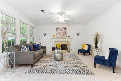 Living room with ceiling fan, ornamental molding, 