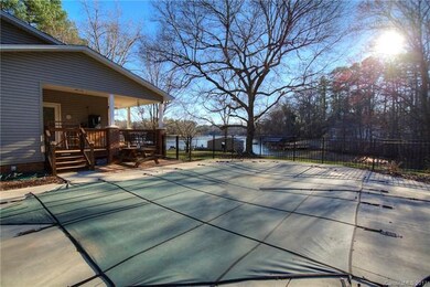 Inground pool right off deck and overlooking lake.