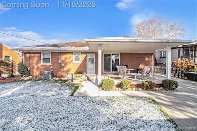 Rear view of property with brick siding and a patio