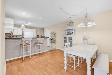 Dining room with baseboards, light wood-style floo
