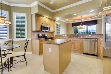 Kitchen featuring stainless steel appliances, granite counters, a kitchen island, and light brown cabinets