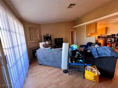 Living area with light wood-style floors and a fireplace