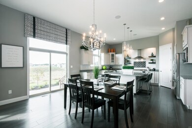 A sliding glass door with a transom window above leads to the aggregate patio!