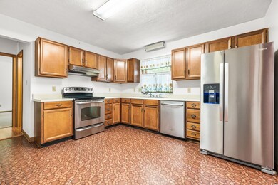 Kitchen with sink, tile flooring, a textured ceili