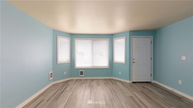 The large bay windows allow light to stream into the main living room.