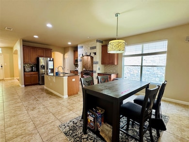 Dining space featuring arched walkways, light til