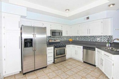 Modern white cabinets with nickel hardware and sta