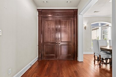 Entrance foyer featuring crown molding and dark ha
