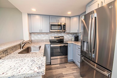 Beautiful updated Kitchen with tile backsplash, custom countertops along with stainless steel appliances.  A chef's dream!