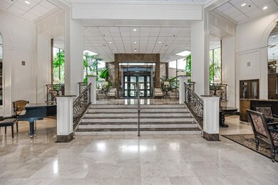 Elegant entryway with grand piano.